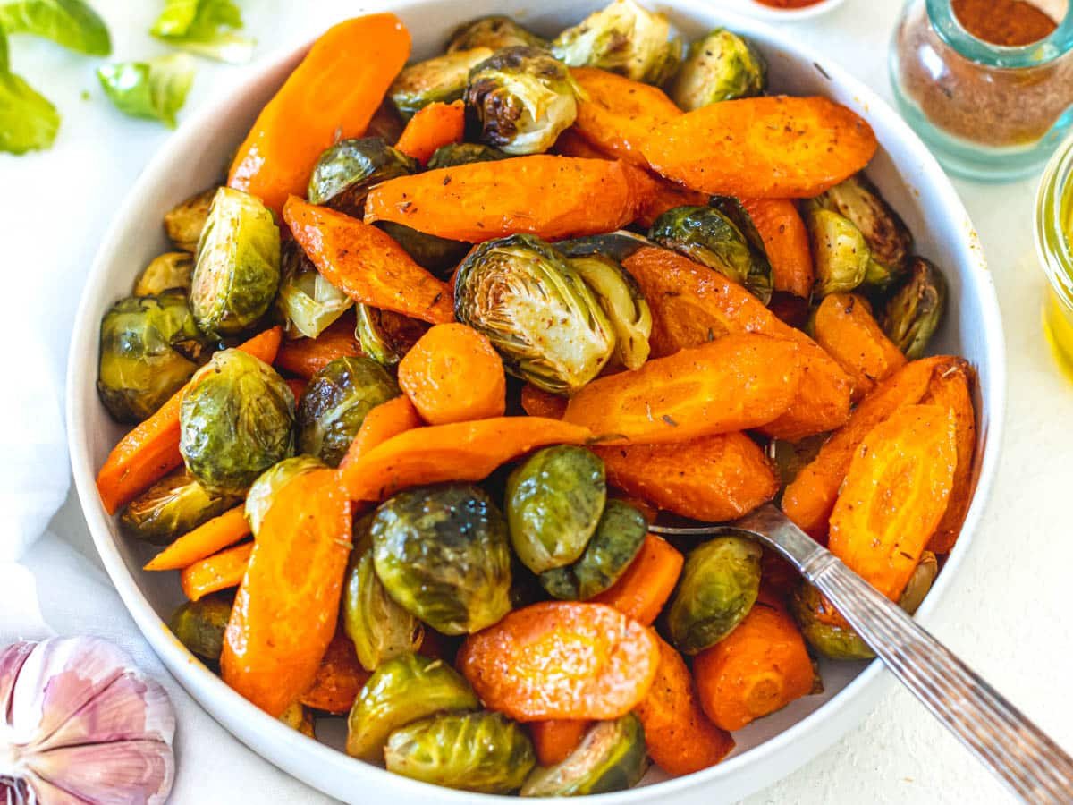 roasted carrots and Brussels sprouts with spoon