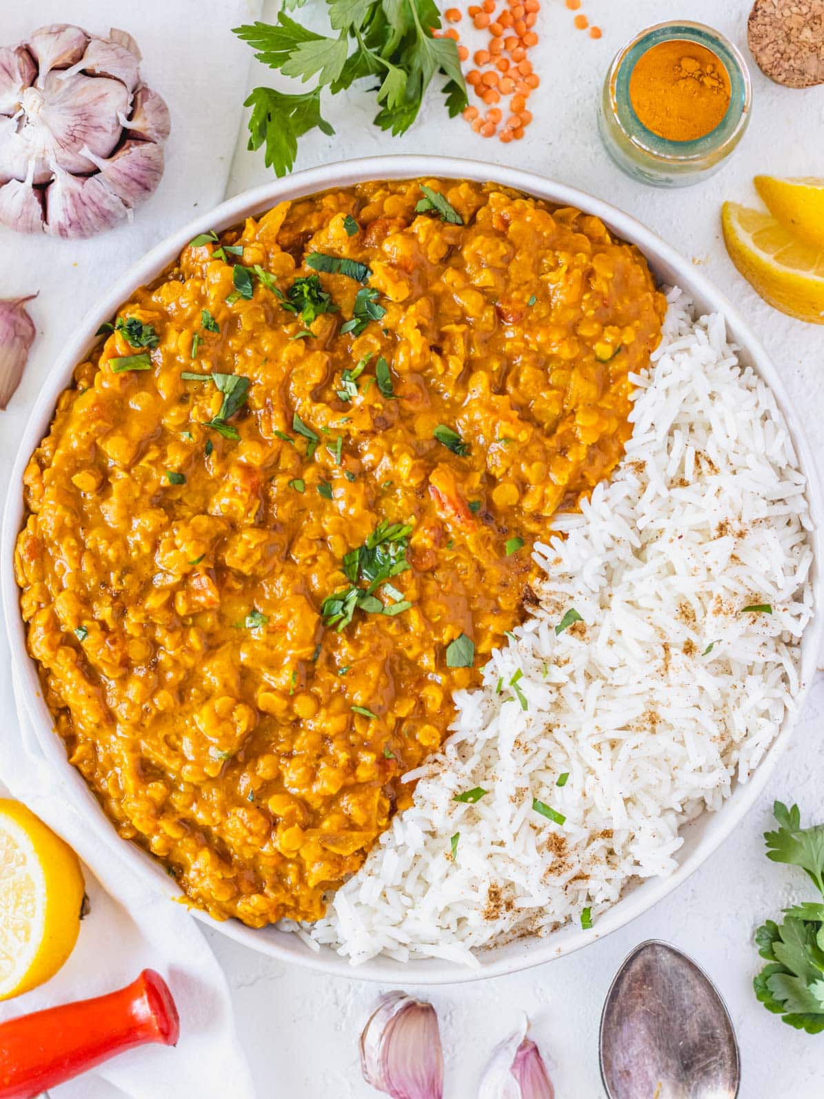 Lentil curry with basmati rice and lemon wedges