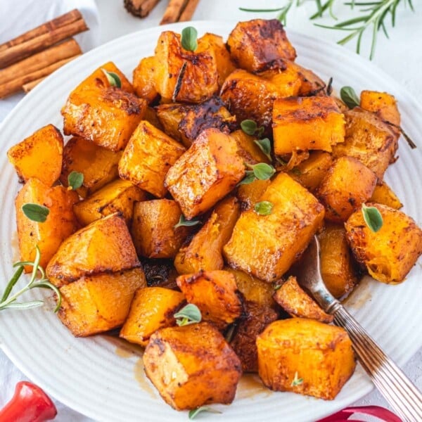 baked butternut squash cubes with cinnamon and fresh herbs