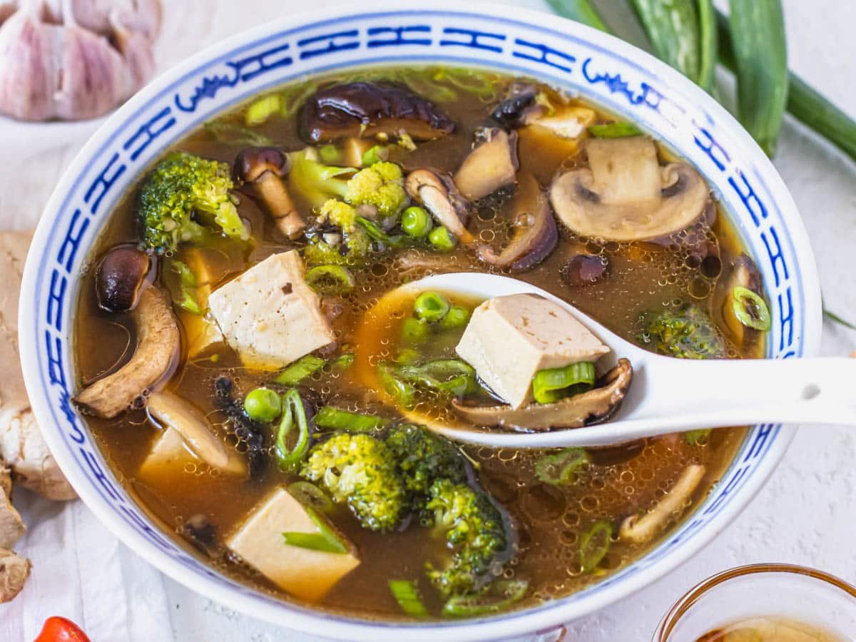 Tofu soup with frozen peas and mushrooms