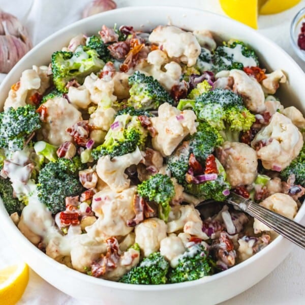 cauliflower broccoli salad with sundried tomatoes and a silver spoon