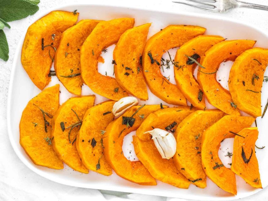 Roasted butternut squash on a platter, seasoned with sage and romsemary