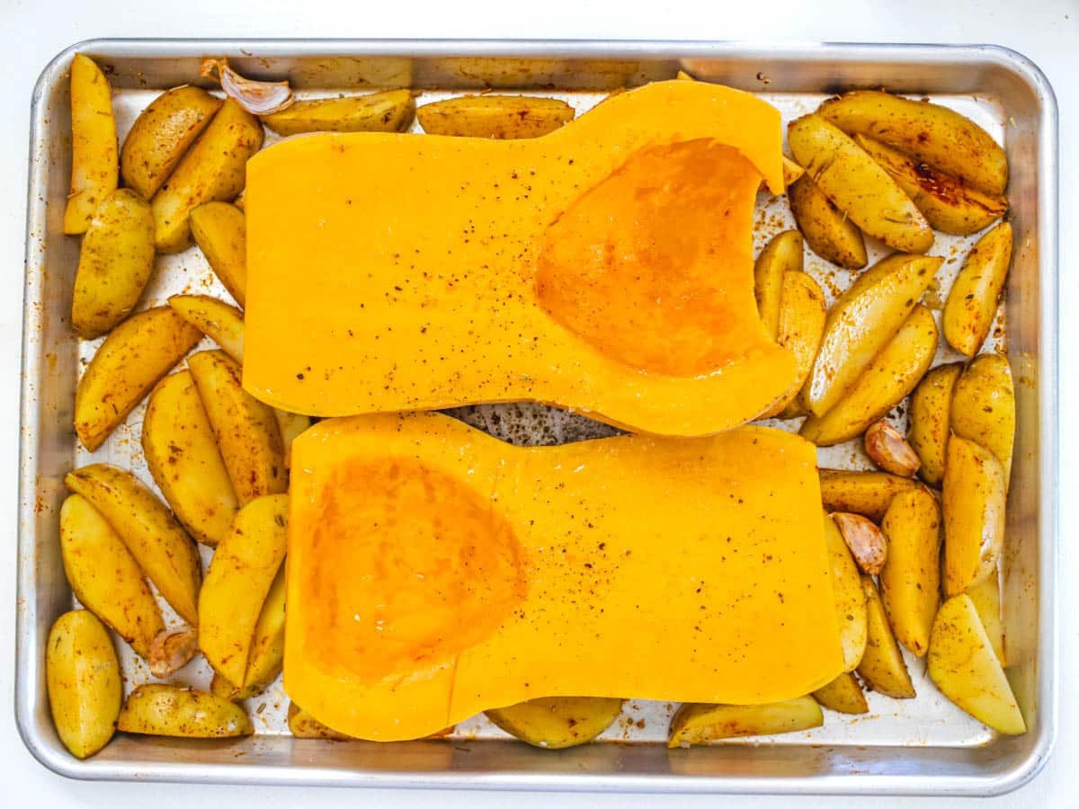 butternut squash and potato wedges on a baking tray