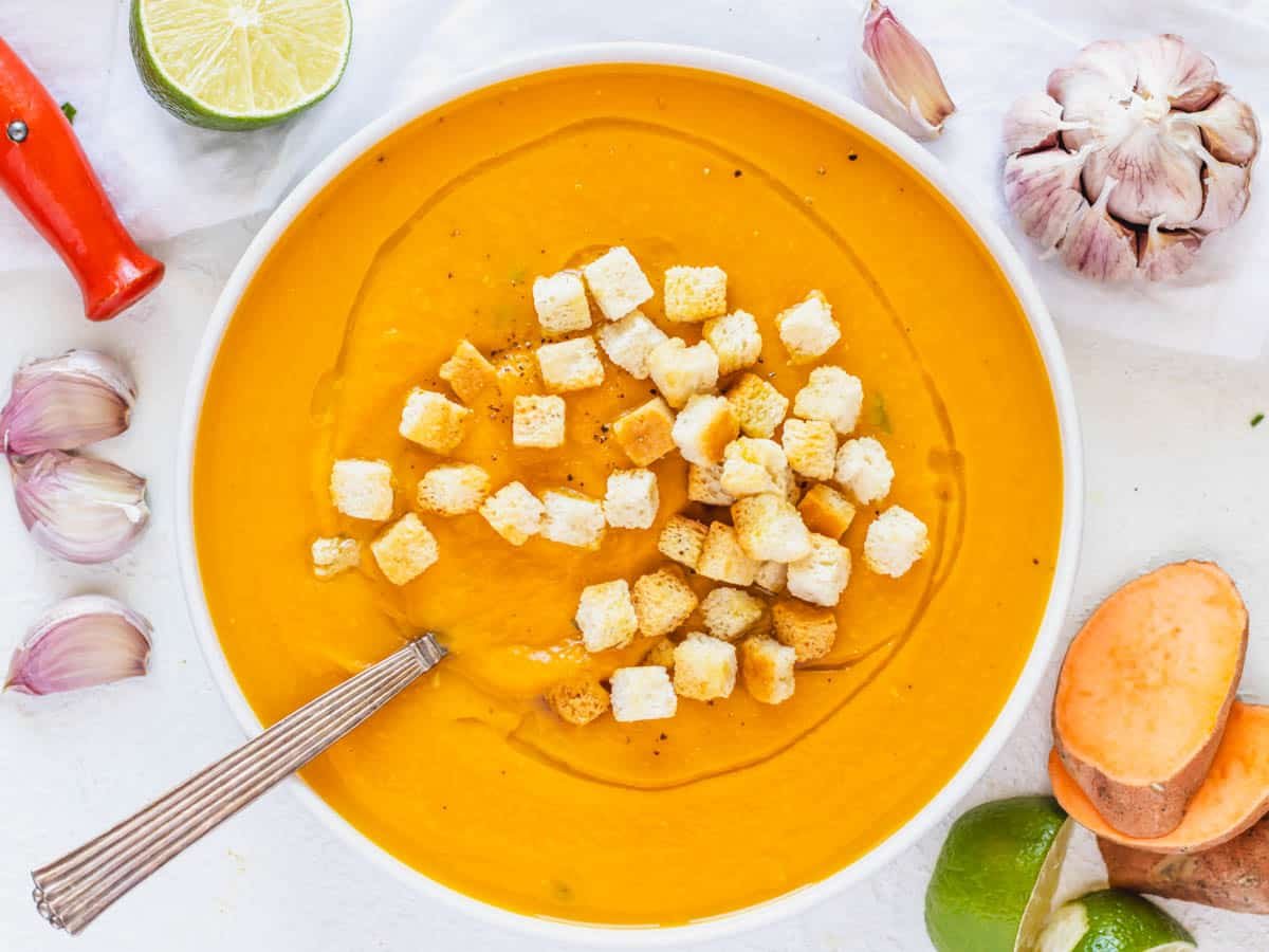 sweet potato soup with croutons and a spoon