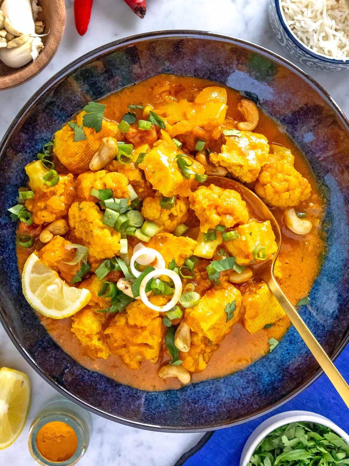 tofu curry with cauliflower in a blue bowl