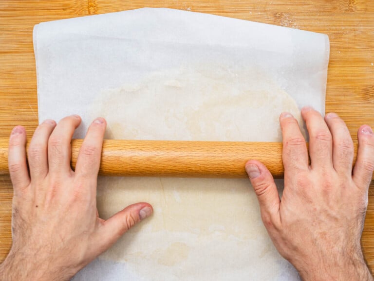 hands with a rolling pin and vegan pie crust