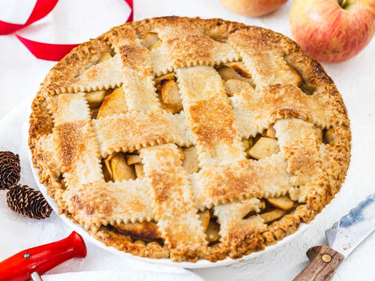 vegan apple pie with red apples and knife on the side