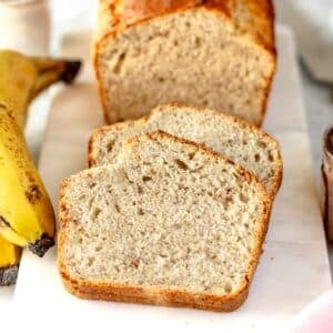 vegan banana bread slices on a white cutting board