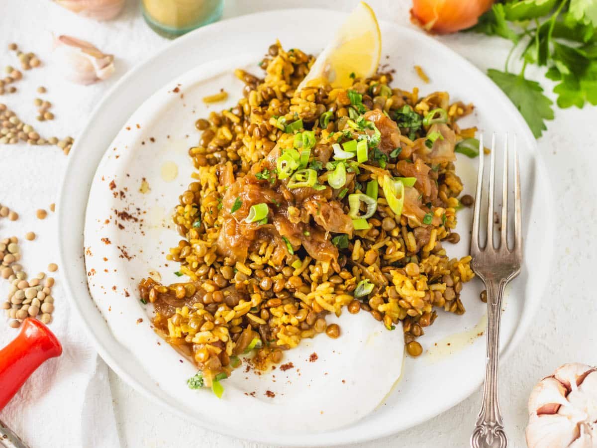 Caramelized onions on lentils and rice served on a white plate