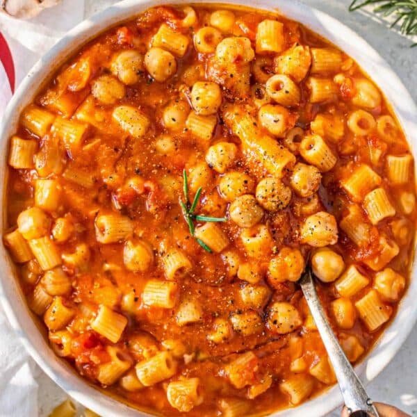 Comforting bowl of Italian pasta with chickpeas on a simple table setting.