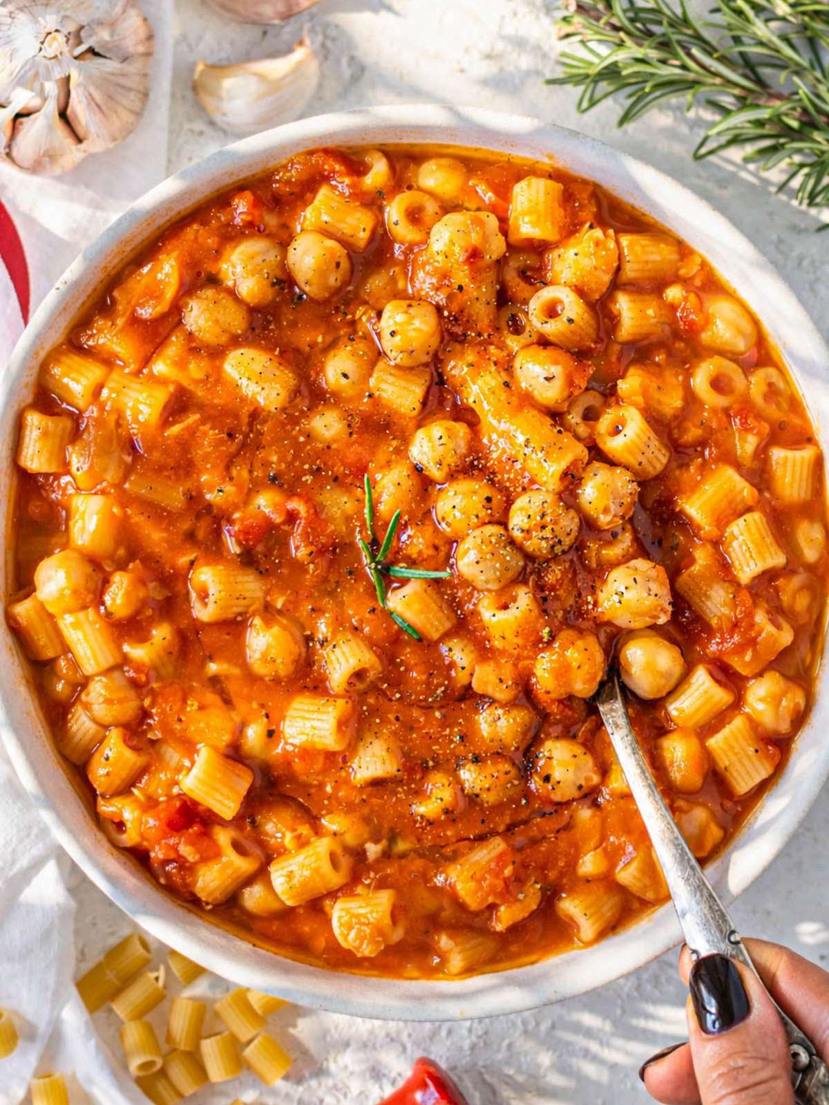 Creamy pasta e ceci in a bowl howing chickpeas and pasta coated in sauce.