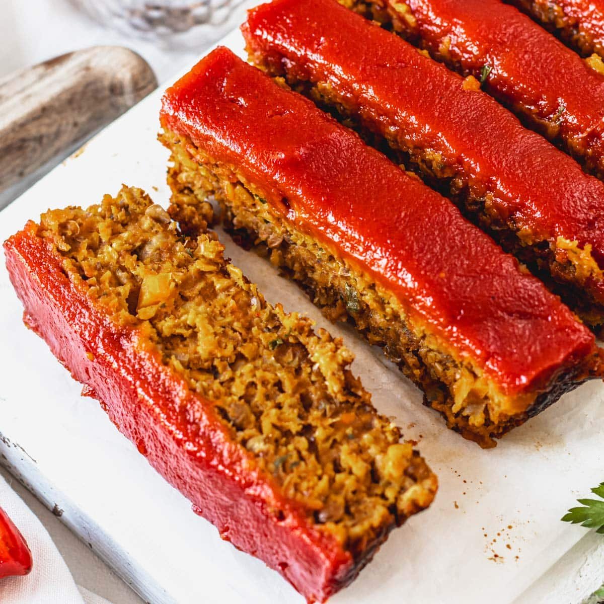 Lentil loaf cut into slices with ketchup sauce