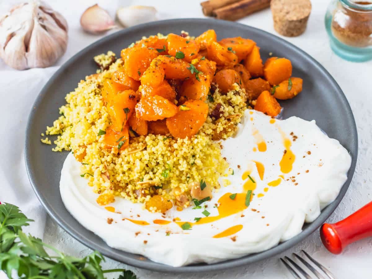 Moroccan couscous served with yogurt and Moroccan carrot salad