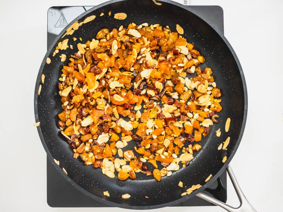 dried fruits and nuts frying in a black skillet