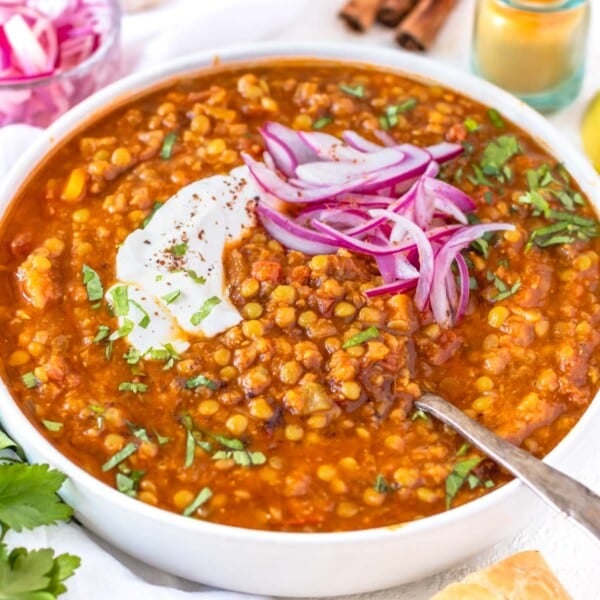 Moroccan lentil soup with spoon and pickled red onions