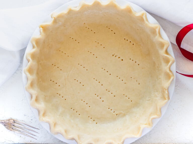 fluted pie crust in a pie dish before baking