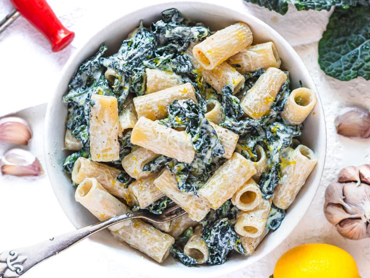 kale pasta in a bowl with silver fork