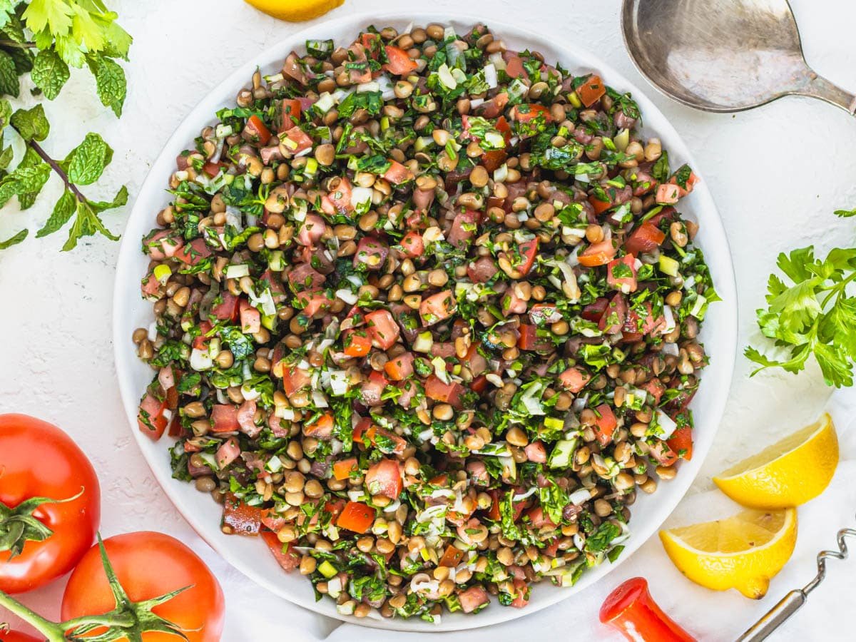 lentil tabbouleh with lemon and tomatoes on the side