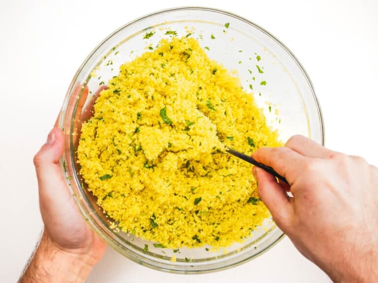 tossing the couscous with olive oil and parsley