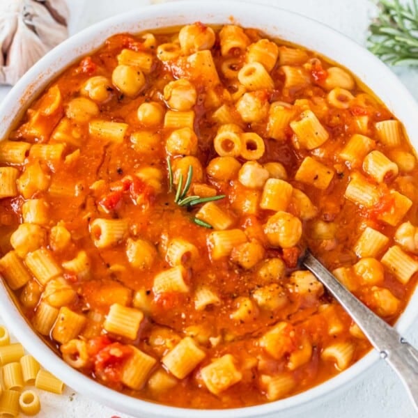 pasta and chickpeas in a bowl with a silver spoon