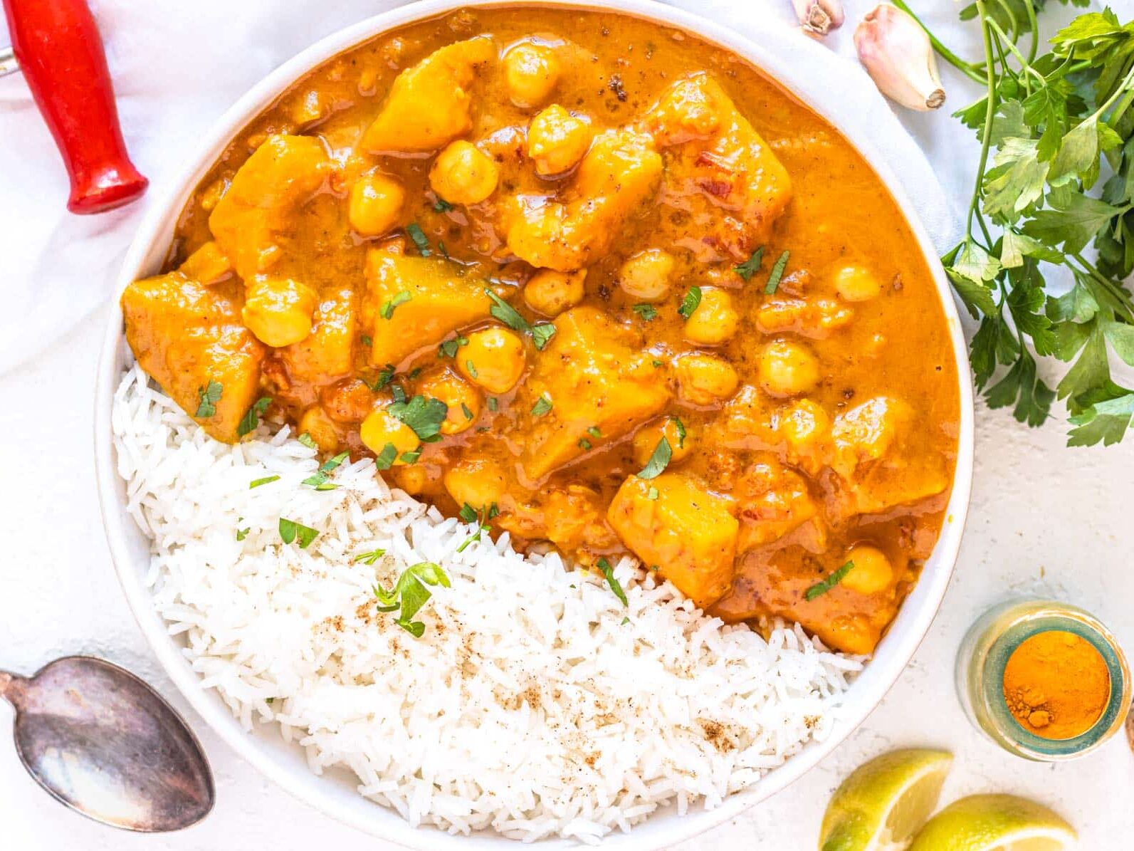 pumpkin curry with rice and a silver spoon