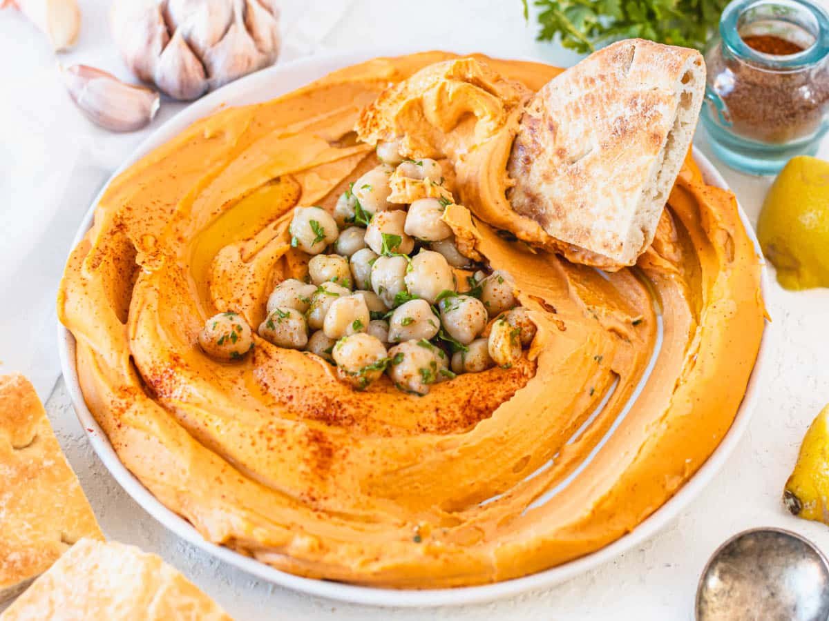roasted red pepper hummus dipped with pita bread