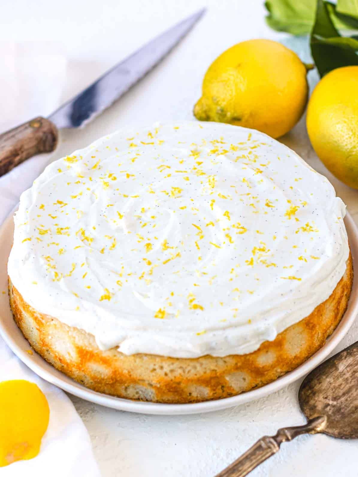 vegan lemon cake with frosting and lemon zest