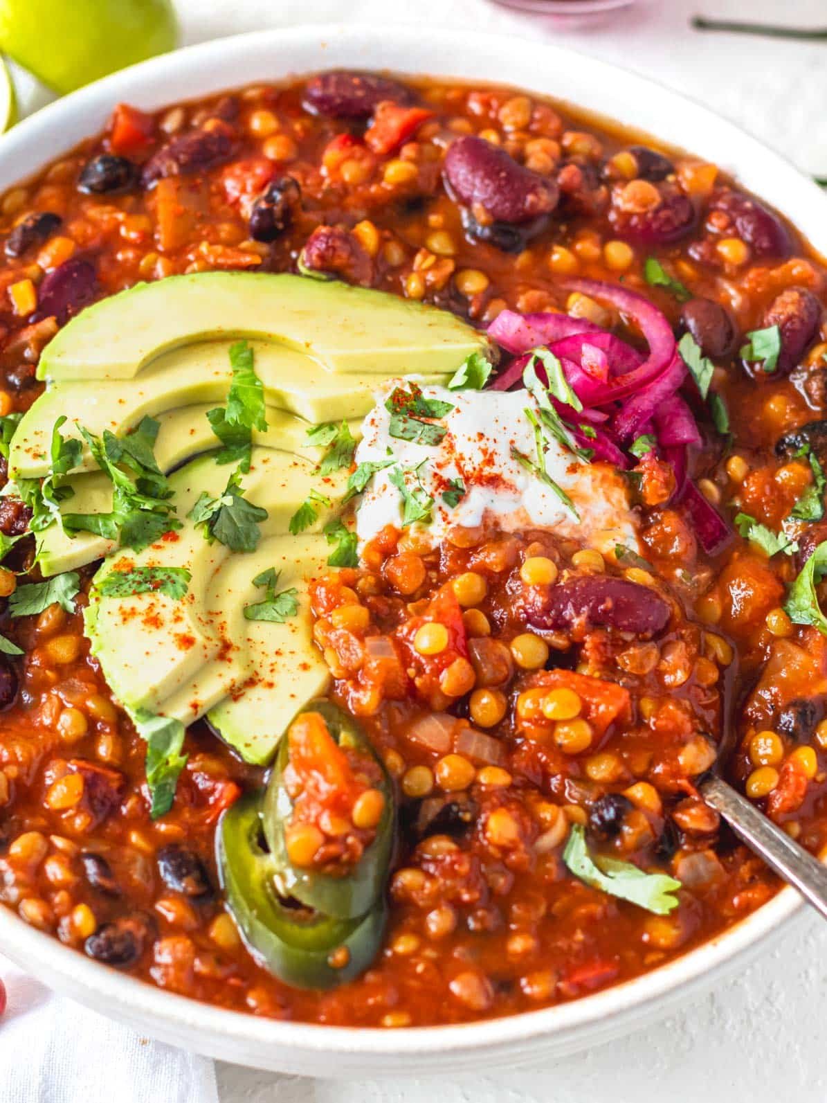 Lentil chili with avocado and pickled red onions