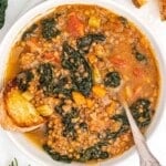 Lentil soup with greens and a silver spoon