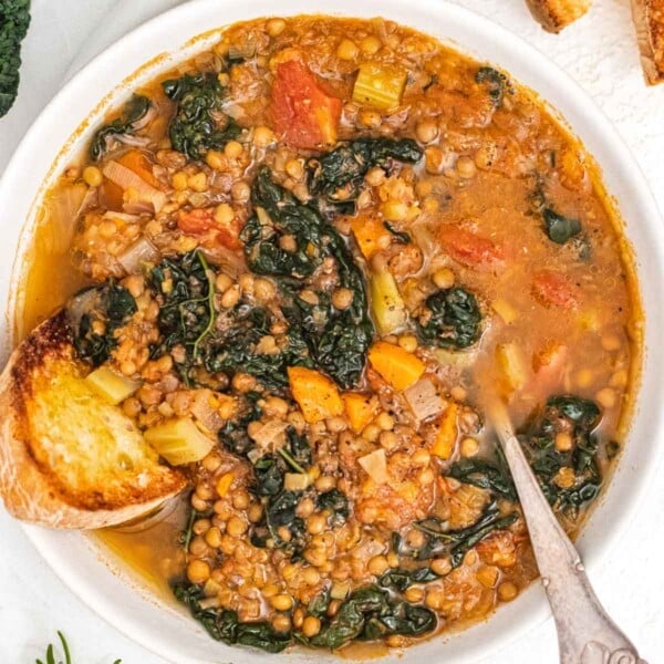Lentil soup with greens and a silver spoon