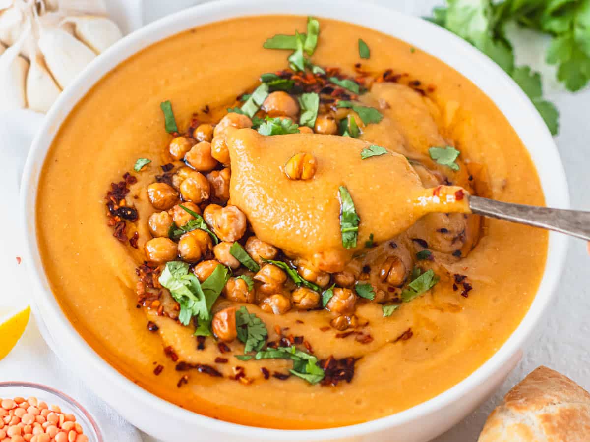 Turkish red lentil soup with roasted chickpeas and fresh cilantro on top