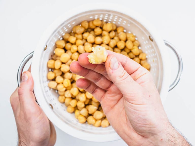 testing the tenderness of chickpeas by squeezing in between fingers