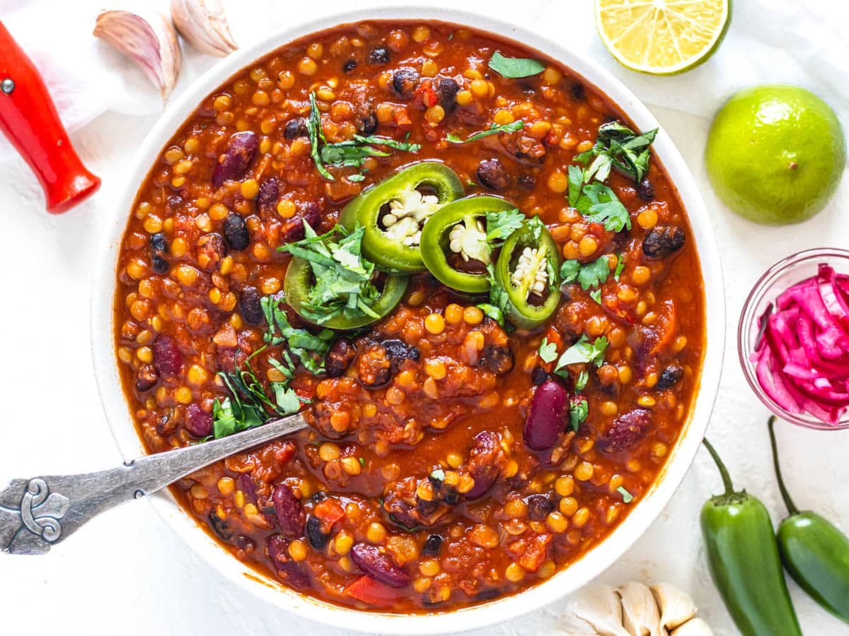 Lentil chili with pickled jalapenos and a spoon