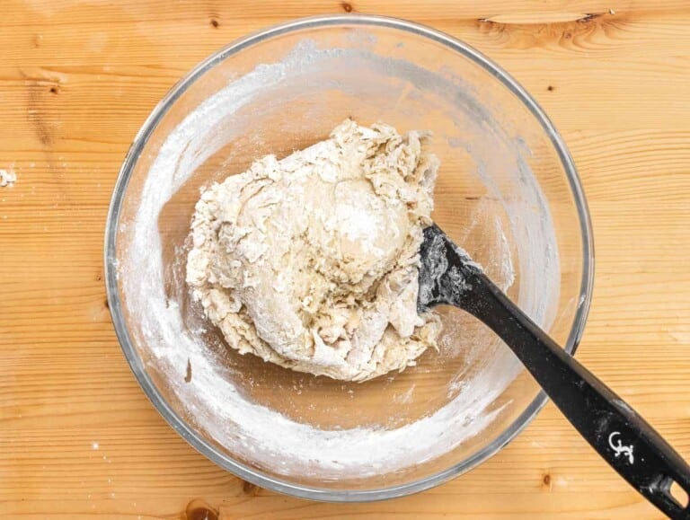 dough in a glass bowl with spatula