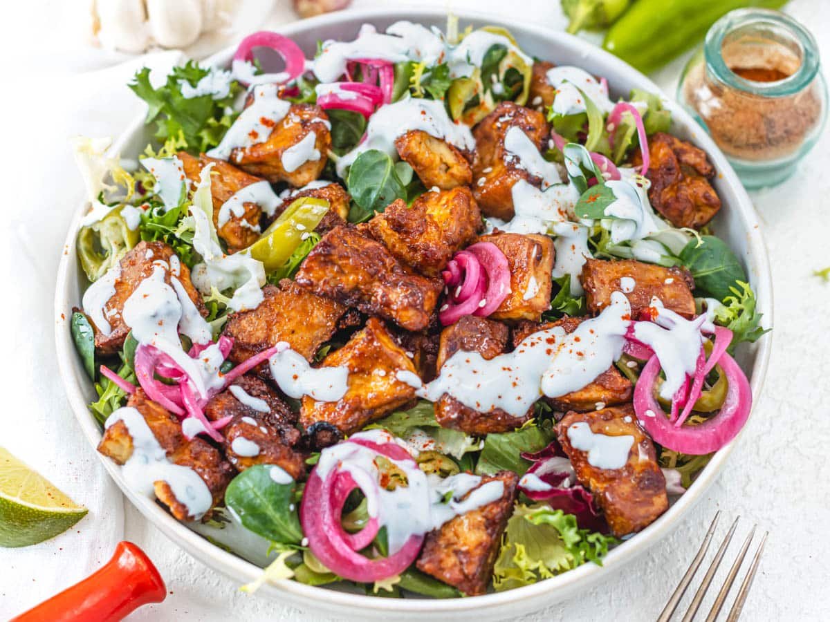 Baked Tofu on a salad with ranch dressing and sesame seeds