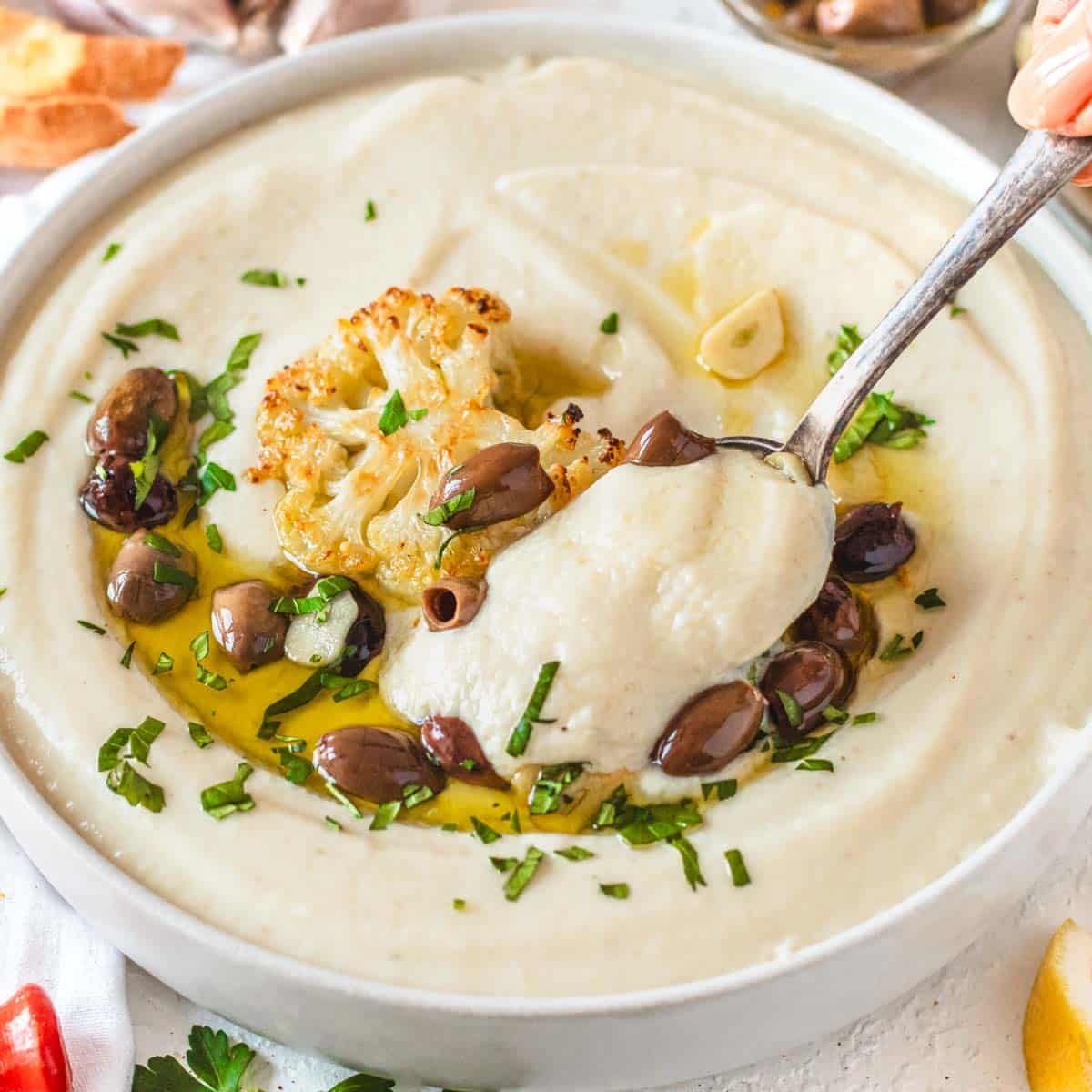 Cauliflower soup with olives and freshly chopped parsley