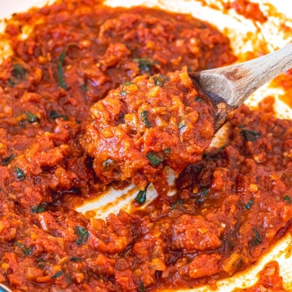 Easy marinara sauce in a skillet with a wooden spoon