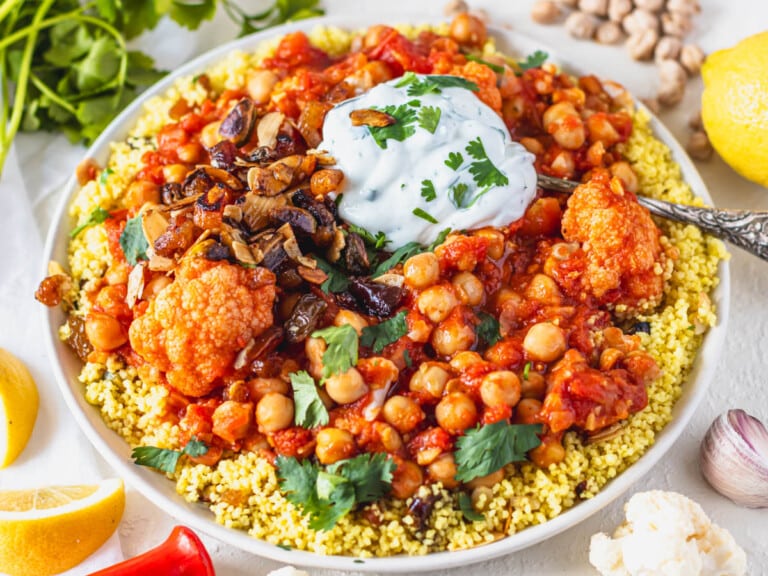 Moroccan chickpea stew served on yellow couscous and a dollop of yogurt