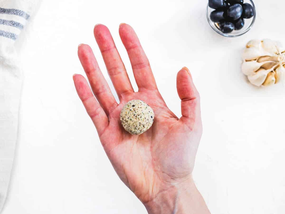 hand holding a small vegan meatball