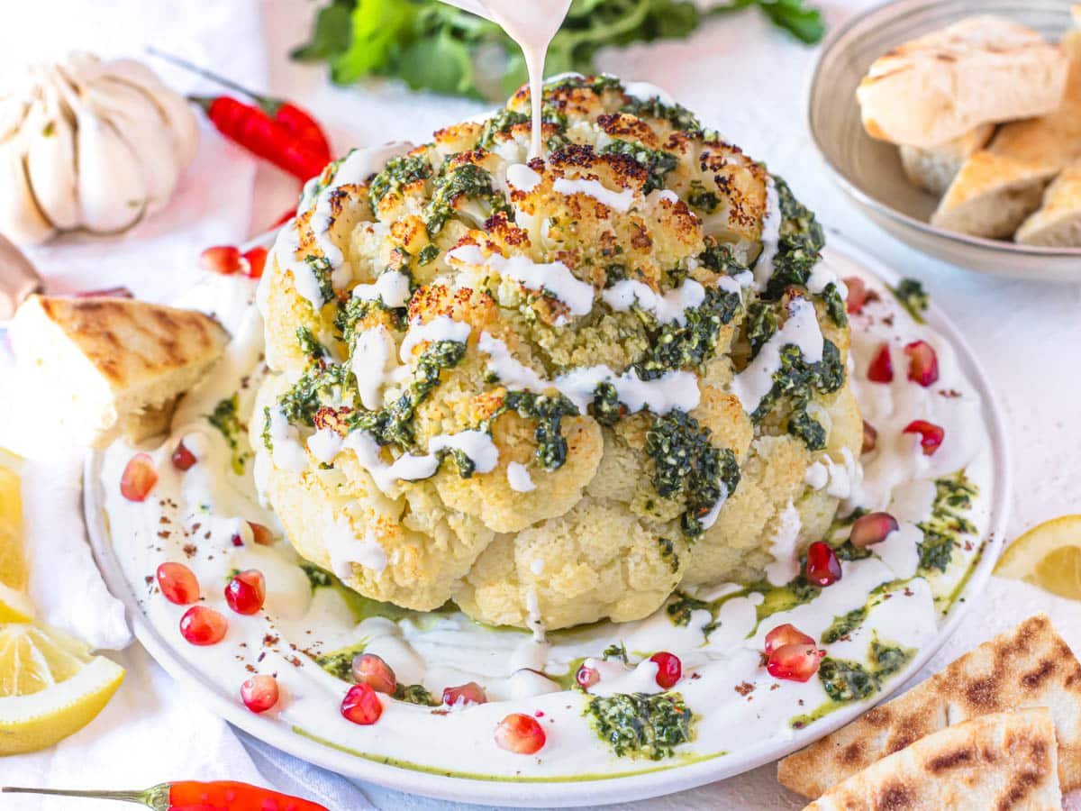 Whole roasted cauliflower with chermoula and drizzle of tahini sauce