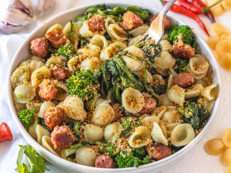 orecchiette with sausage, broccoli rabe and breadcrumbs in a white plate