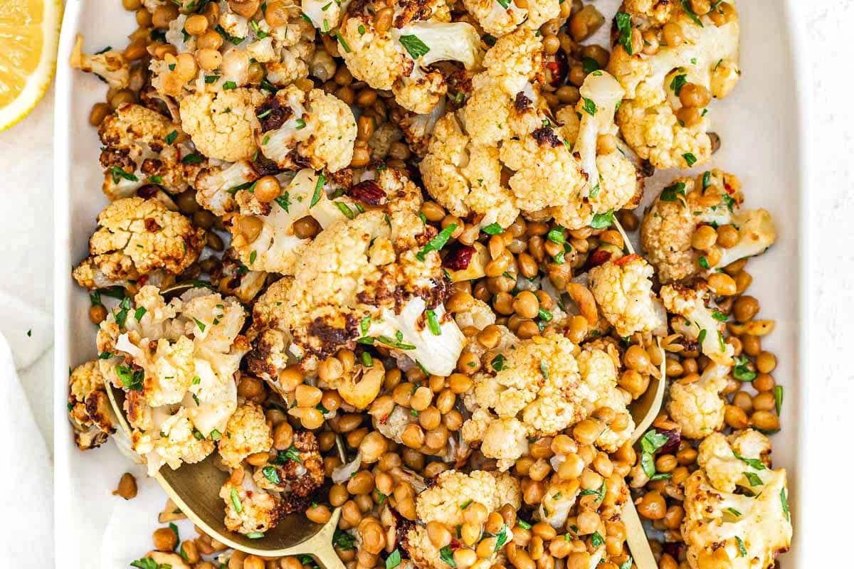 Cauliflower lentil salad with parsley on a white platter
