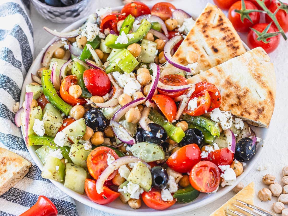 Greek chickpea salad with pita bread and crumbled feta