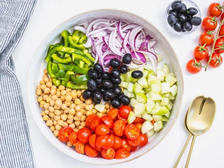 chopped vegetables, chickpeas, and olives in a salad bowl