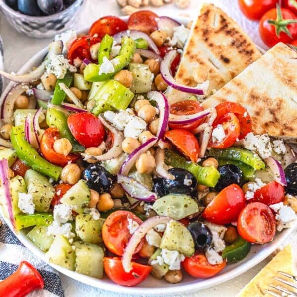 Greek chickpea salad with olives and pita bread on a plate