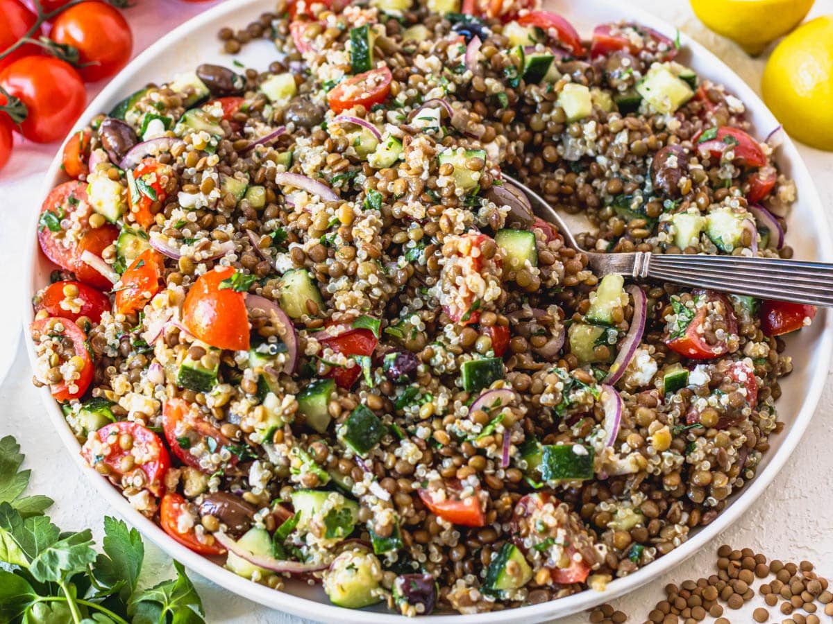 Lentil salad with quinoa and a silver spoon