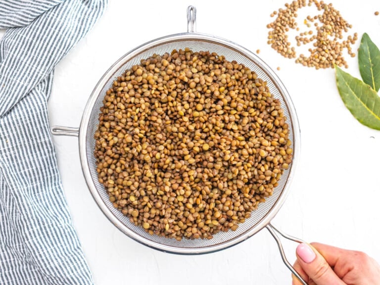 Cooked and rinsed lentils in a sift