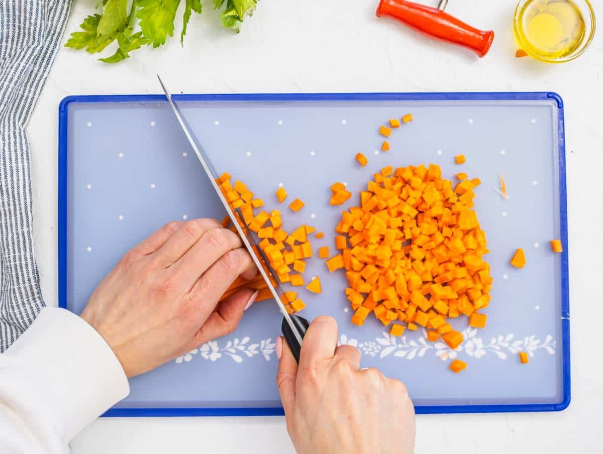 female hands chopping carrot
