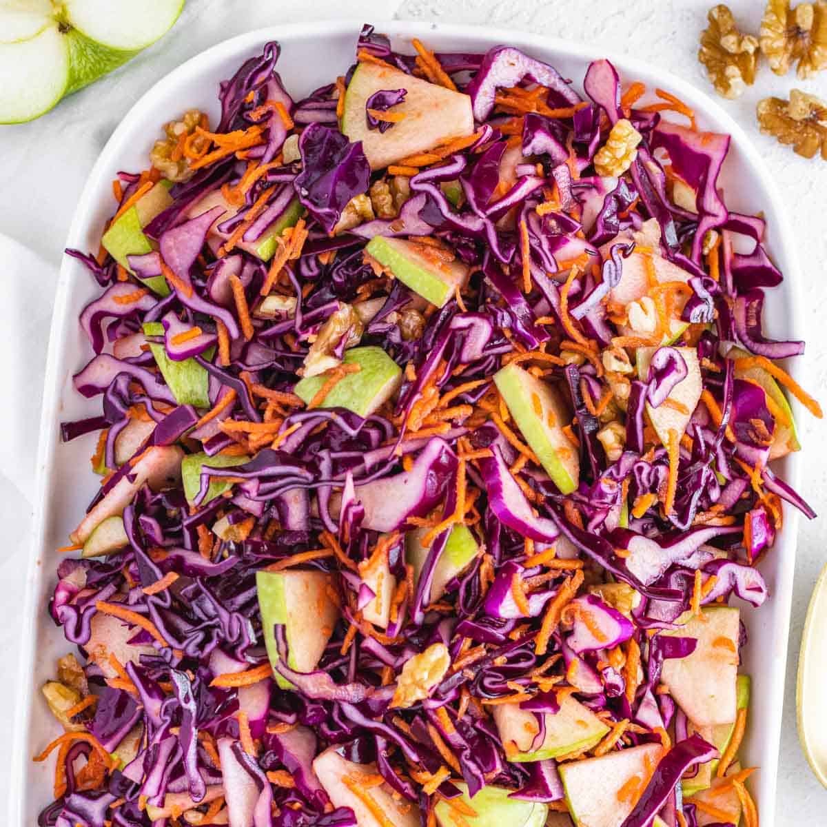 no mayo coleslaw with vinegar, green apple and red cabbage on a platter