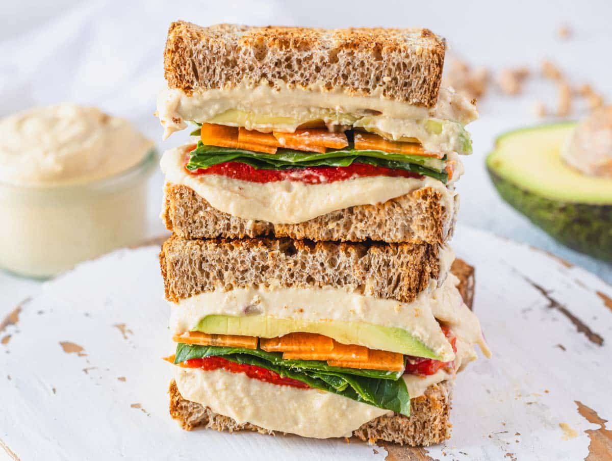 Hummus sandwich with avocado on the side